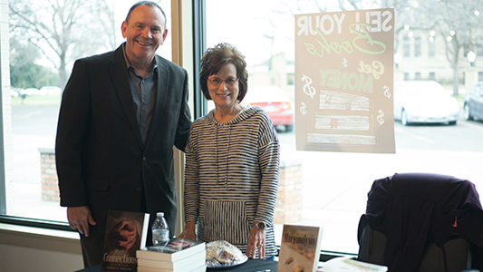 SAGU President Kermit Bridges with Karen Norton during the book signing