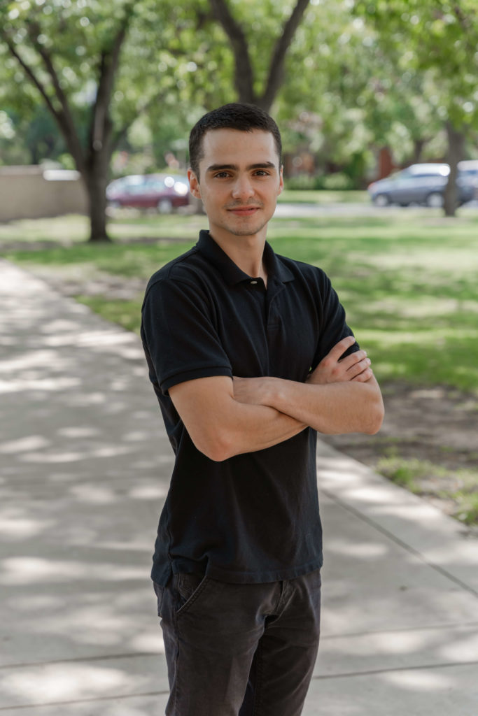 SAGU business major in black shirt with arms crossed